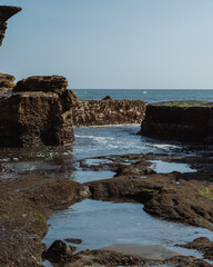 Fototapeta premium BALI, INDONESIA Beach and breaking Indian Ocean waves, Bali. Tanah Lot Temple