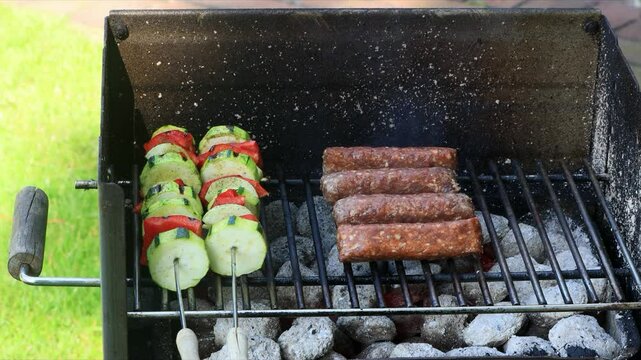 cevapcici and vegetable skewers on grill

