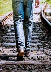 A person walking on train tracks
