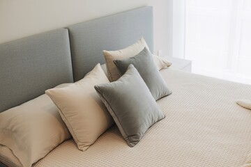 Cozy bedroom with gray headboard and cream bedding