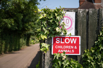 &ldquo;SLOW children and animals&rdquo; road sign on Government Row, Enfield, warning drivers to reduce speed in a residential area with trees nearby.