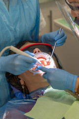 Woman receiving dental care in a modern clinic with professional staff