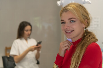 Dentist consultation with a woman smiling warmly in a clinic environment