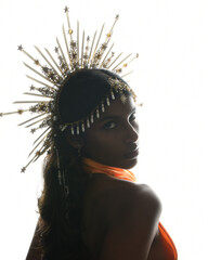 Regal silhouette portrait of a female model in an ornate crown and golden rim lighting, featuring a...