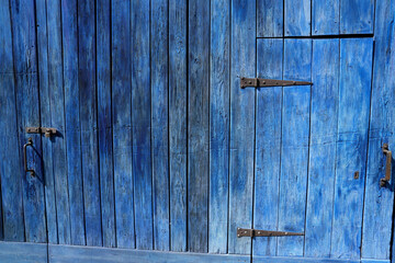 faded blue wooden wall / door of old barn as background