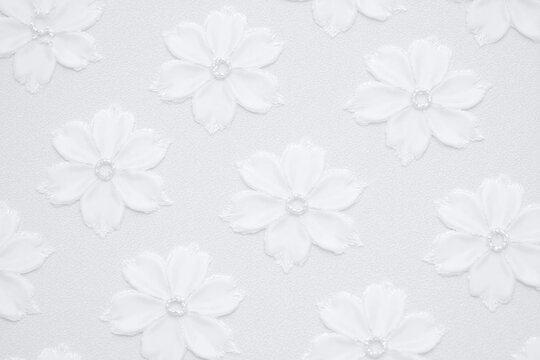 close up of a white lace fabric with flowers on it