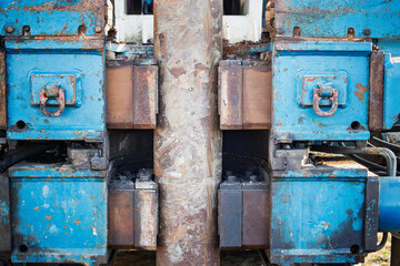 Equipment for drilling with blue machinery showing wear and tear at a construction site during daylight