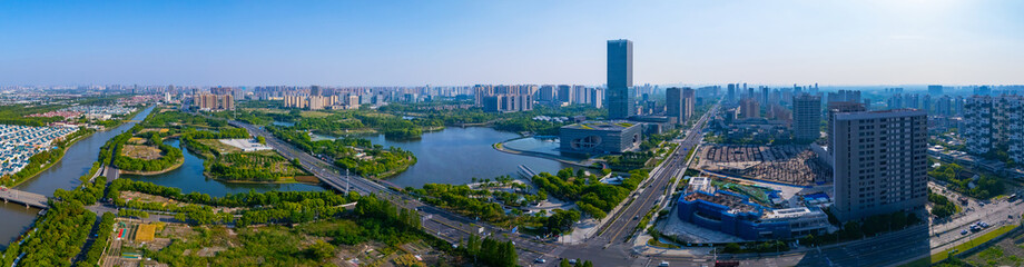 Aerial view of skyscrapers with beautiful lake garden on sunny day, Jiading central district,...