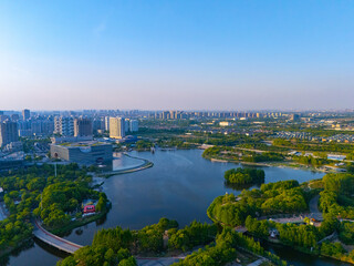 Aerial view of skyscrapers with beautiful lake garden at sunset, Jiading central district, Shanghai.