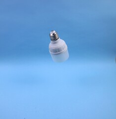 Modern Energy-Saving Light Bulb With Minimalist Blue Backdrop