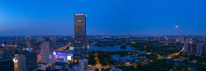 Aerial view of skyscrapers with beautiful lake garden at dusk, Jiading central district, Shanghai.