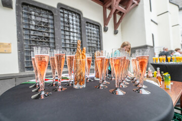 Pouring and tasting of dry sparkling wine champagne festival wedding setup guests