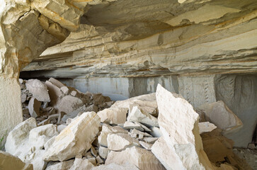 Ancient rock-cut dwelling destroyed by earthquake, showing large tufa debris inside. Historical site in Cavusin, Cappadocia, Turkey 