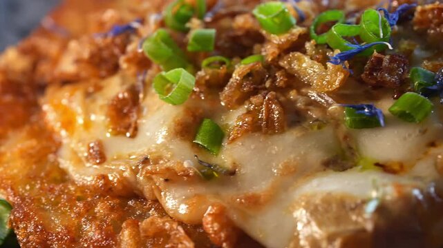 Potato pancakes with sauce, green onions and flowers.