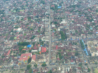 Aerial view of Pekanbaru city skyline in Riau, Sumatra, Indonesia, featuring urban buildings, housing