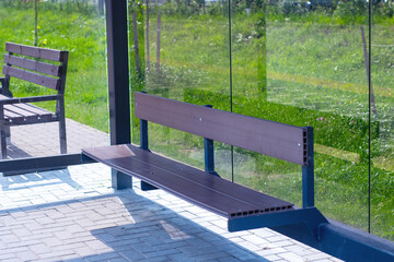 A beautifully crafted wooden bench sits conveniently in front of a glass wall