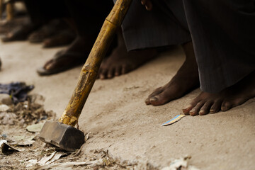 view of Workers' feet taking rest. A hammer is also visible 