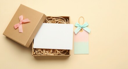 Open gift box with white mockup card inside and a cute pastel tag on beige background, perfect for personalized message or showcasing a thoughtful present for any occasion.