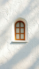 Fototapeta premium Arched wooden window framed by a textured white stucco wall bathed in sunlight creating a serene architectural detail.