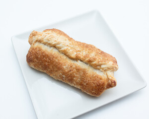 a bun with an apple on a white plate