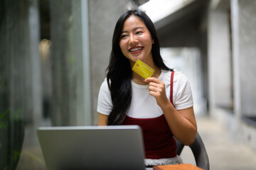 Happy customer making secure online payment using laptop and credit card