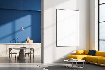Naklejka na ściany i meble Modern living room and kitchen interior with yellow sofa, round table, and large blank framed poster on white wall for mockup display concept. 3D Rendering