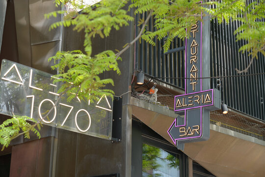 exterior building facade and signs outside Aleria located at 1070 Queen Street West, Toronto