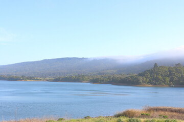 beautiful landscape with lake and mountain.Landscape view of a lake in the morning with fog and blue sky
