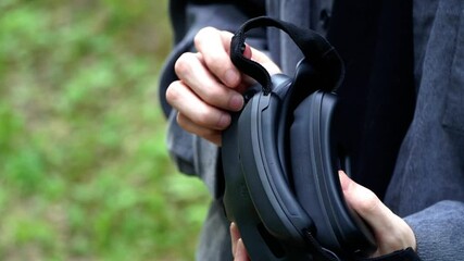 Man pulls goggles out of his bag to control the drone - Powered by Adobe