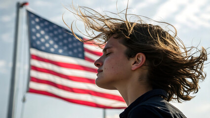 Tranquil Portrait of a Young Man with American Flag Backdrop at Windy Weather and Close Eyes
