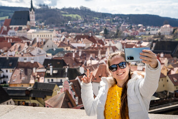 Mujer turista compartiendo las vistas de český krumlov con una selfie