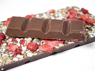 Milk chocolate decorated with freeze-dried strawberry and lemon