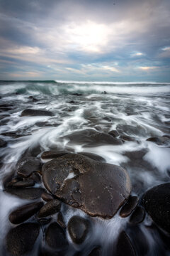 Receding Tide During a Moody Morning on a Black Rock Beach
