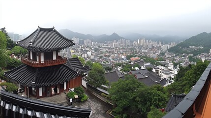 Naklejka premium Panoramic view of a city nestled in mountains, seen from a traditional building's elevated vantage point. A misty atmosphere adds depth