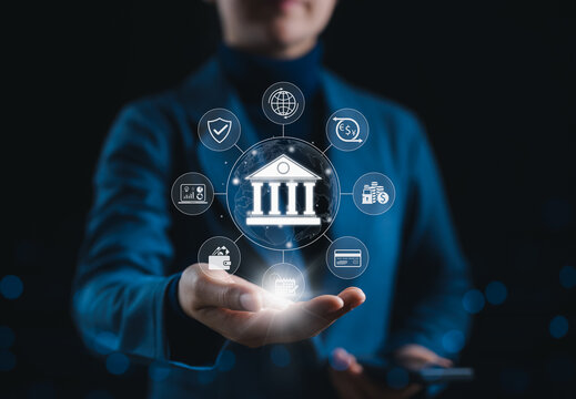 Digital banking and financial technology concept. Businessperson presents icon of bank with financial symbols, representing digital banking services, fintech innovation, and global finance operations.