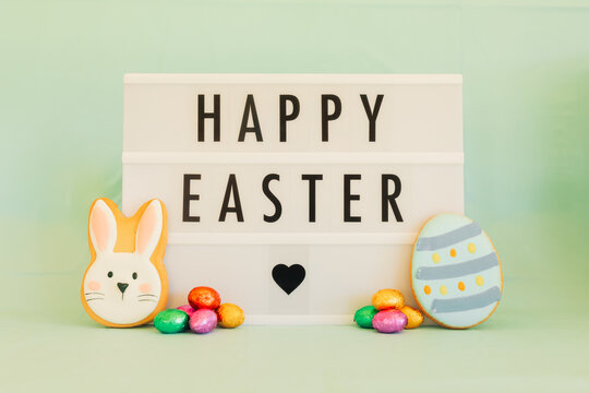 Happy Easter letter board with cookies and colorful chocolate eggs