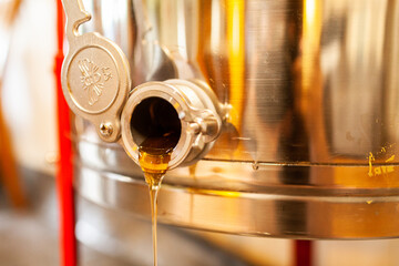 raw honey dripping from honey extractor machine - honey harvest