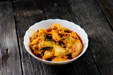 Sichuan fried chicken with vegetables on a dark background. Chinese cuisine. Food concept