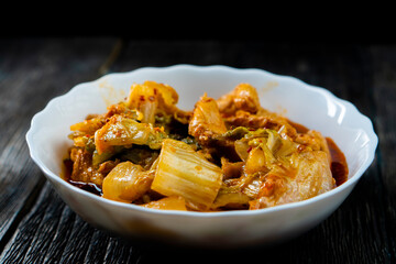 Sichuan fried chicken with vegetables on a dark background. Chinese cuisine. Food concept