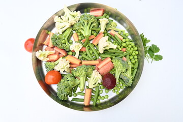 Vibrant medley of fresh vegetables. Features broccoli, cauliflower, tomatoes, Carrot, green beans, and peas. colourful vegetables of spring time, Its good for health. colorful display.