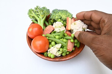 Vibrant medley of fresh vegetables. Features broccoli, cauliflower, tomatoes, Carrot, green beans, and peas. colourful vegetables of spring time, Its good for health. colorful display.