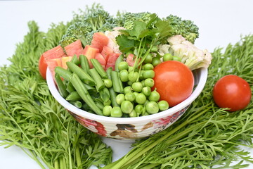 Vibrant medley of fresh vegetables. Features broccoli, cauliflower, tomatoes, Carrot, green beans, and peas. colourful vegetables of spring time, Its good for health. colorful display.