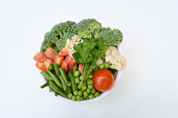 Vibrant medley of fresh vegetables. Features broccoli, cauliflower, tomatoes, Carrot, green beans, and peas. colourful vegetables of spring time, Its good for health. colorful display.