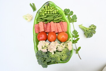 Vibrant medley of fresh vegetables. Features broccoli, cauliflower, tomatoes, Carrot, green beans, and peas. colourful vegetables of spring time, Its good for health. colorful display.