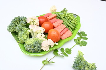 Vibrant medley of fresh vegetables. Features broccoli, cauliflower, tomatoes, Carrot, green beans, and peas. colourful vegetables of spring time, Its good for health. colorful display.