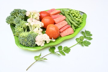 Vibrant medley of fresh vegetables. Features broccoli, cauliflower, tomatoes, Carrot, green beans, and peas. colourful vegetables of spring time, Its good for health. colorful display.
