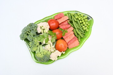Vibrant medley of fresh vegetables. Features broccoli, cauliflower, tomatoes, Carrot, green beans, and peas. colourful vegetables of spring time, Its good for health. colorful display.
