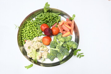 Vibrant medley of fresh vegetables. Features broccoli, cauliflower, tomatoes, Carrot, green beans, and peas. colourful vegetables of spring time, Its good for health. colorful display.