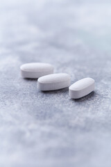 Amino acids tablets on wooden background. Soft focus. Close up	