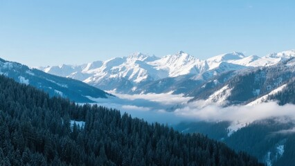 Fototapeta premium Snow-Capped Mountains with Foggy Valley and Pine Forest